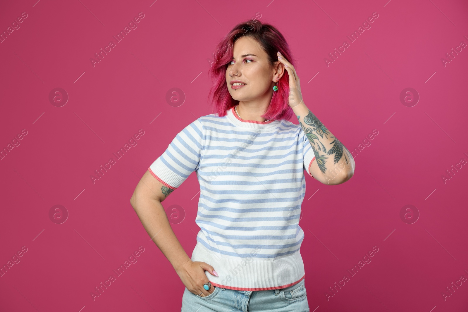 Beautiful woman with bright dyed hair on pink background Photo of Beautiful woman with bright dyed hair on pink background