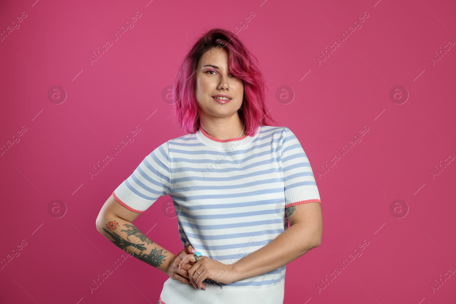 Beautiful woman with bright dyed hair on pink background Photo of Beautiful woman with bright dyed hair on pink background