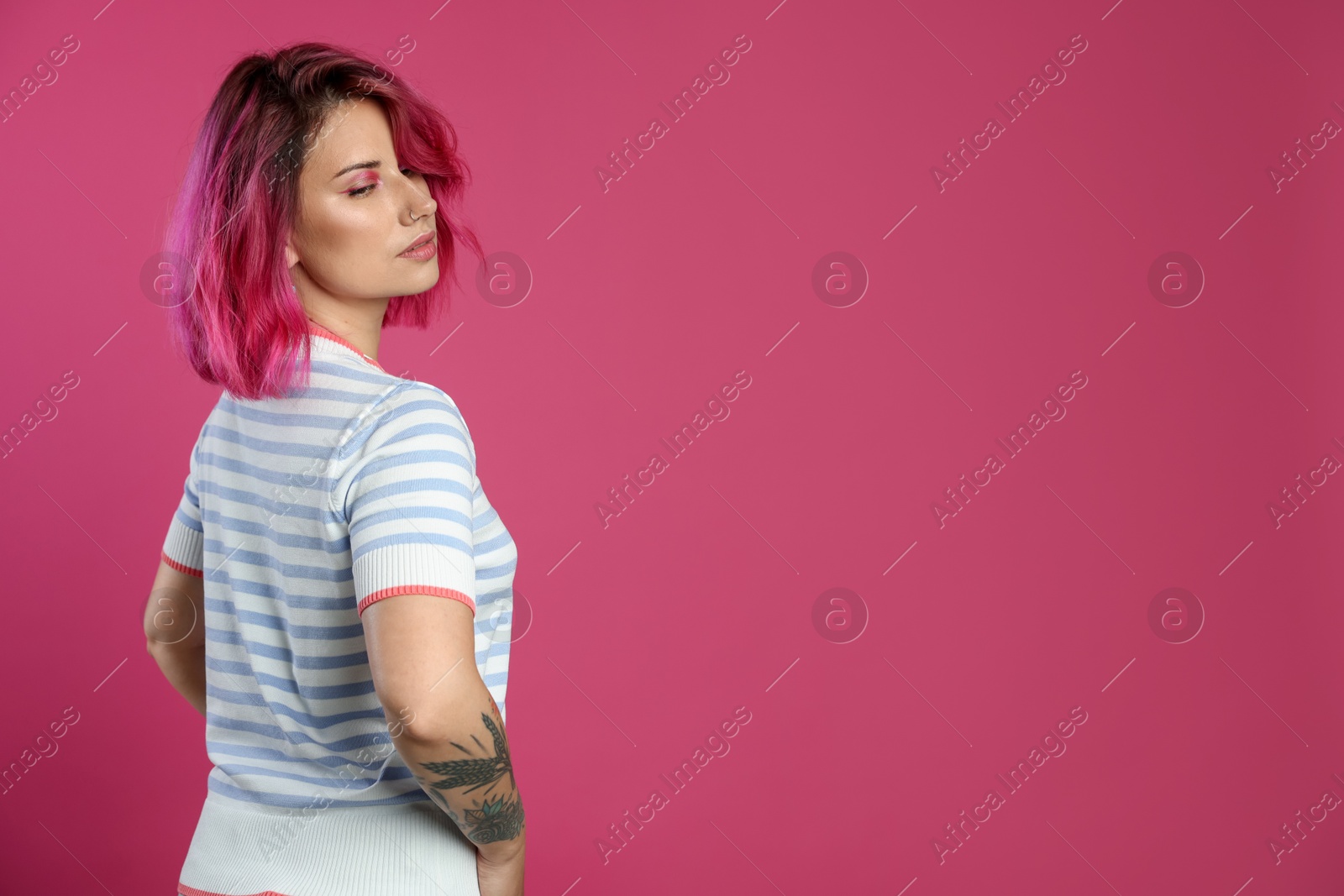 Beautiful woman with bright dyed hair on pink background, space for text Photo of Beautiful woman with bright dyed hair on pink background, space for text
