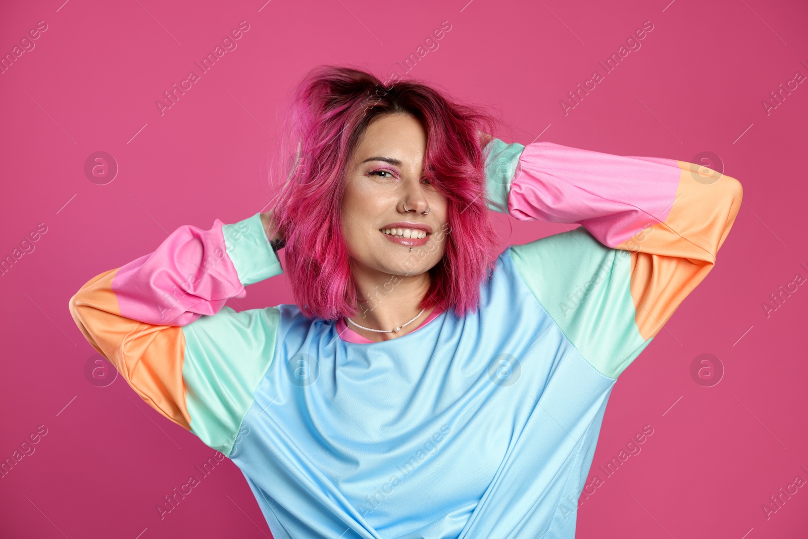 Beautiful woman with bright dyed hair on pink background Photo of Beautiful woman with bright dyed hair on pink background