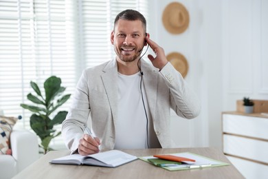 Photo of Travel agent working at wooden table in office