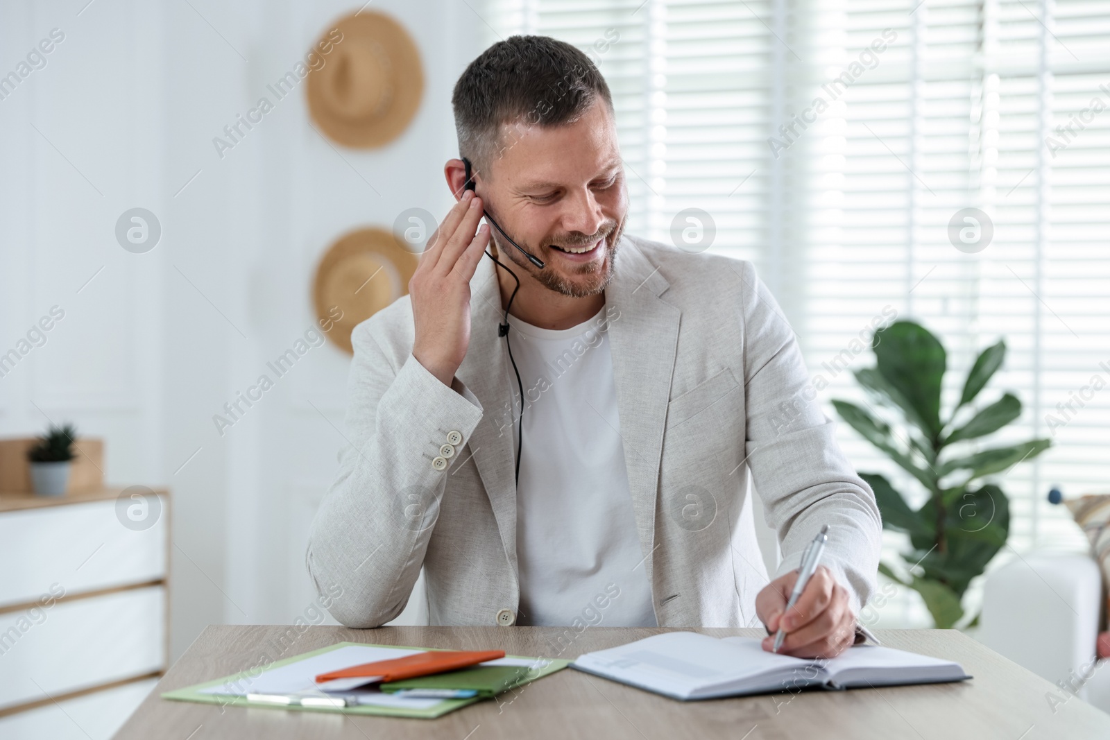 Travel agent working at wooden table in office Photo of Travel agent working at wooden table in office