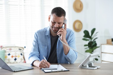 Photo of Travel agent working at wooden table in office