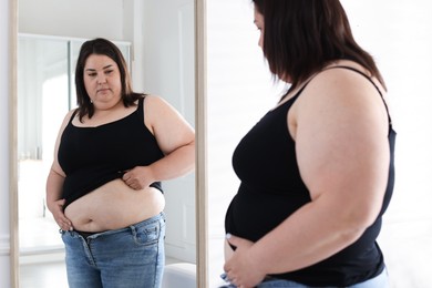 Photo of Woman with excessive belly fat near mirror indoors. Overweight problem