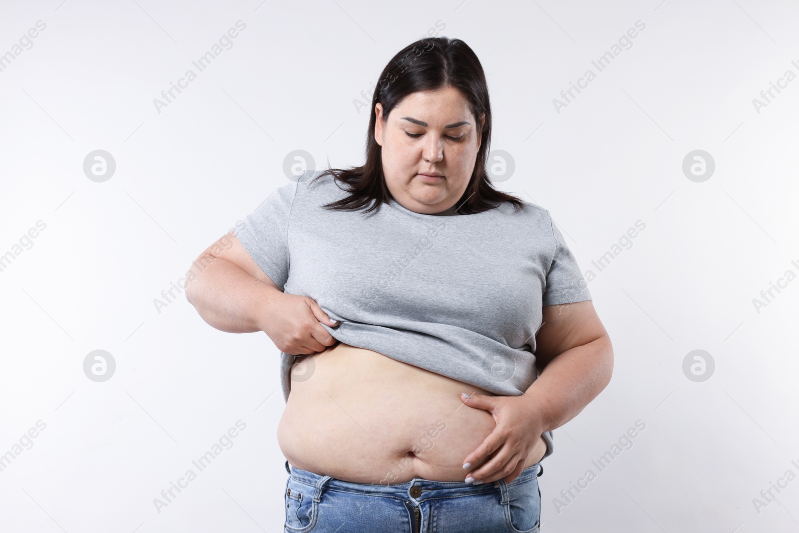 Photo of Woman with excessive belly fat on white background