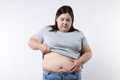 Photo of Woman with excessive belly fat on white background
