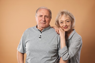 Photo of Portrait of lovely senior couple on beige background