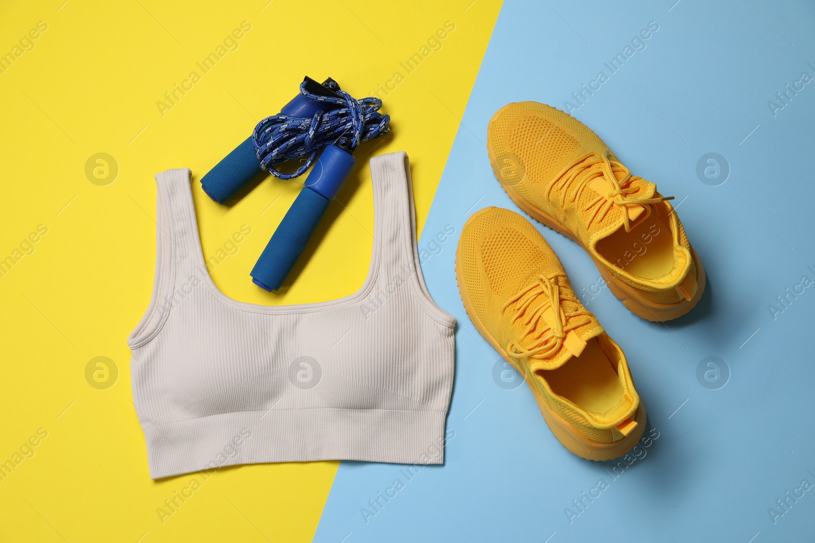 Sportswear, sneakers and skipping rope on color background, flat lay Photo of Sportswear, sneakers and skipping rope on color background, flat lay