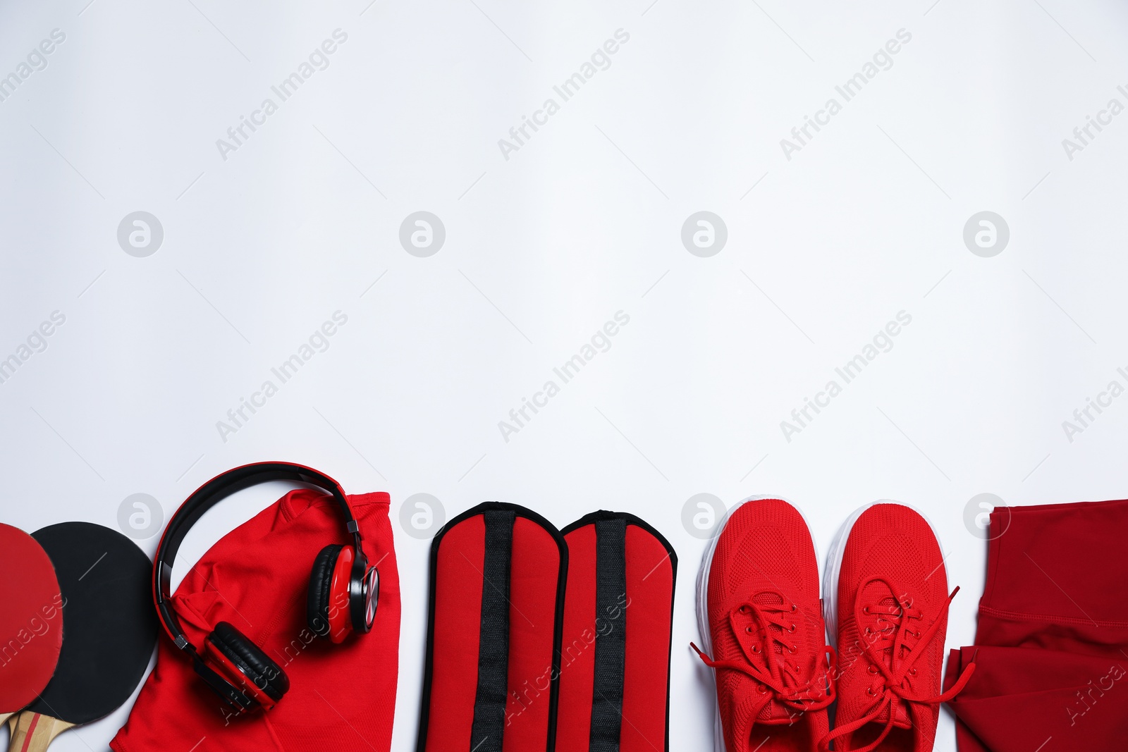 Sportswear and different gym accessories on white background, flat lay. Space for text Photo of Sportswear and different gym accessories on white background, flat lay. Space for text