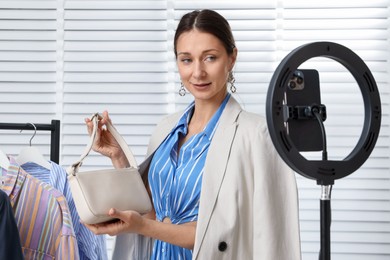 Photo of Professional stylist having online consultation with client via smartphone indoors