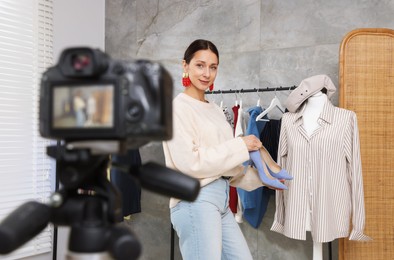 Photo of Professional stylist filming video on camera indoors