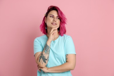 Photo of Beautiful woman with bright dyed hair on pink background