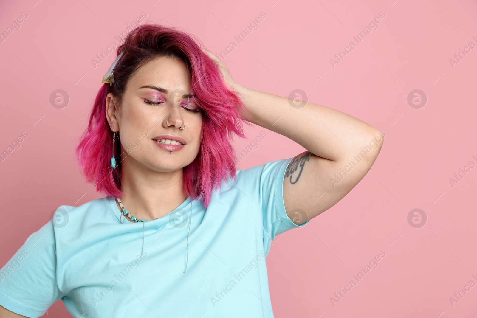 Beautiful woman with bright dyed hair on pink background Photo of Beautiful woman with bright dyed hair on pink background