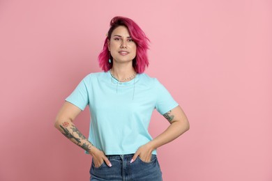 Photo of Beautiful woman with bright dyed hair on pink background