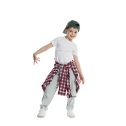 Photo of Happy little boy in baseball hat dancing on white background