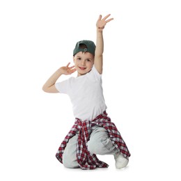 Photo of Happy little boy in baseball hat dancing on white background