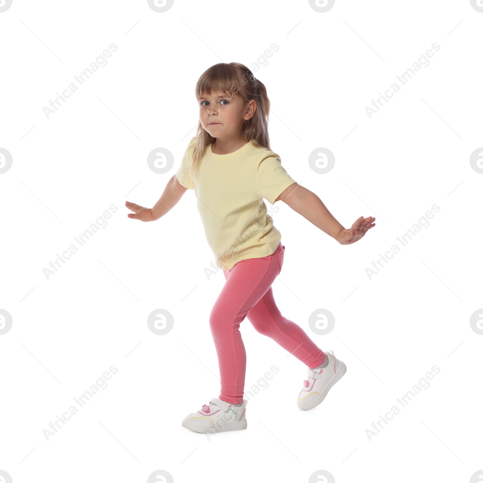 Cute little girl dancing on white background Photo of Cute little girl dancing on white background