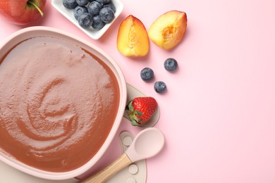 Photo of Baby food. Tasty puree in bowl, spoon and ingredients on pink table, flat lay. Space for text