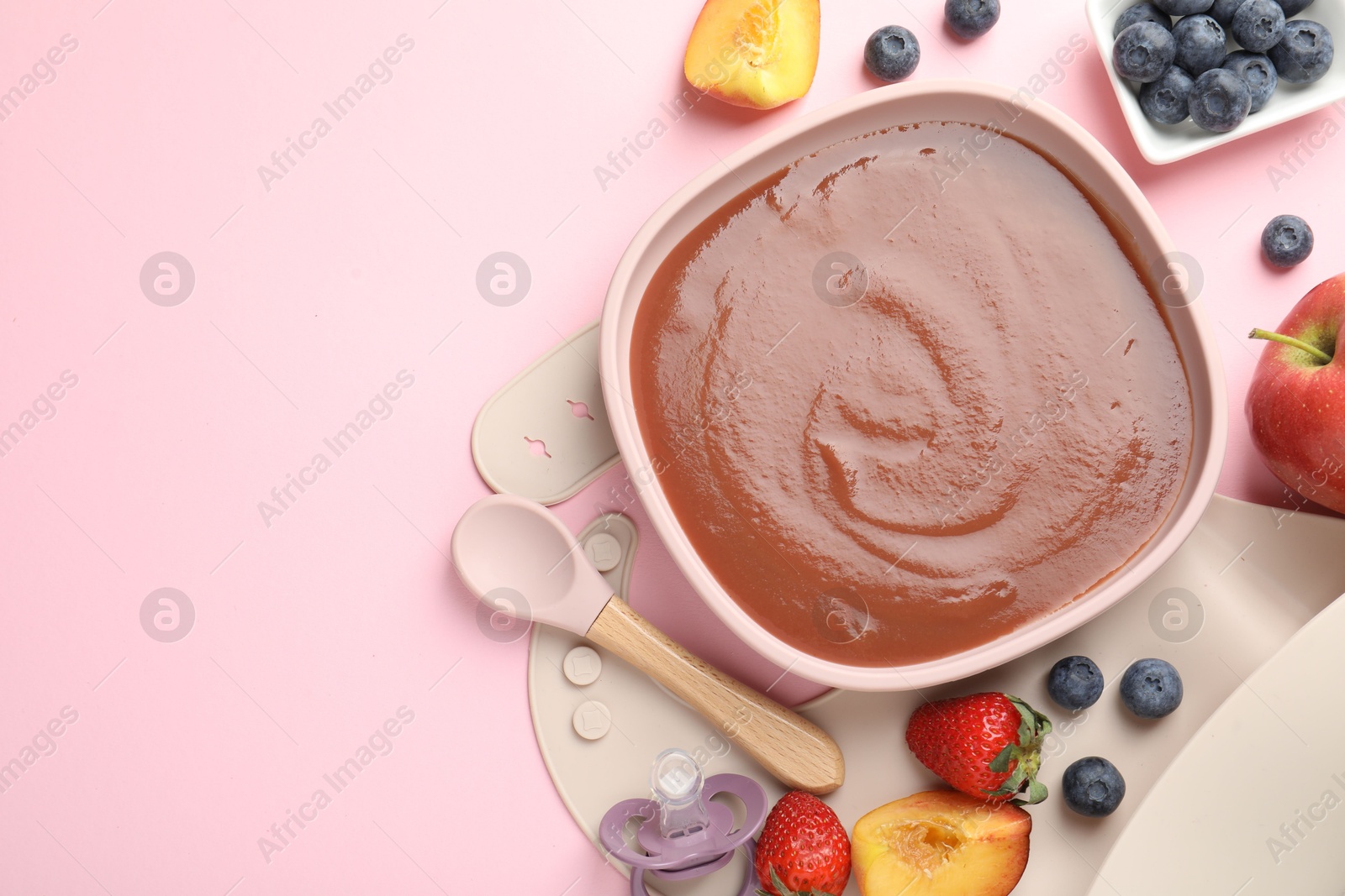 Baby food. Tasty puree in bowl, spoon and ingredients on pink table, flat lay. Space for text Photo of Baby food. Tasty puree in bowl, spoon and ingredients on pink table, flat lay. Space for text