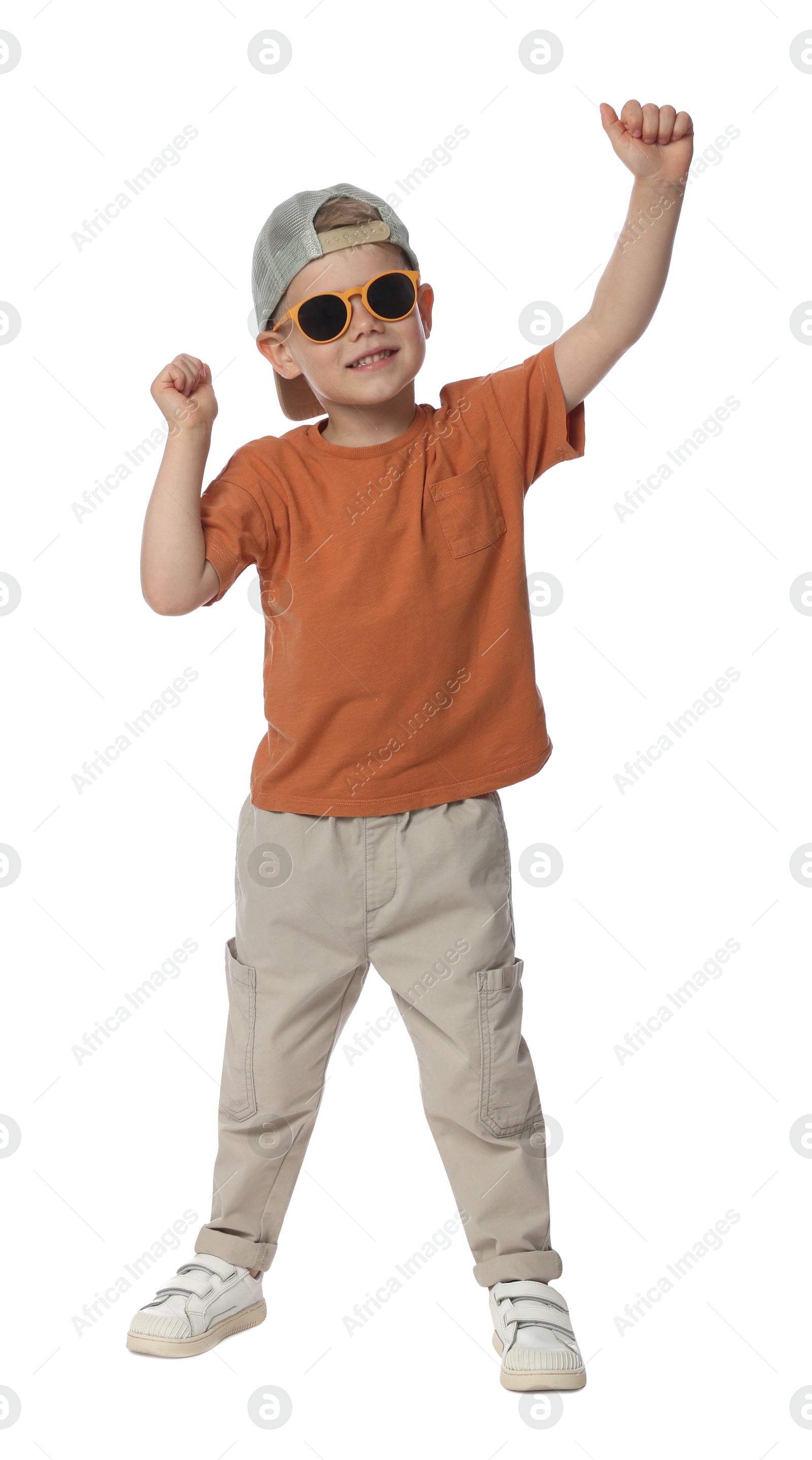 Happy little boy with sunglasses dancing on white background Photo of Happy little boy with sunglasses dancing on white background