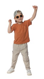 Photo of Happy little boy with sunglasses dancing on white background