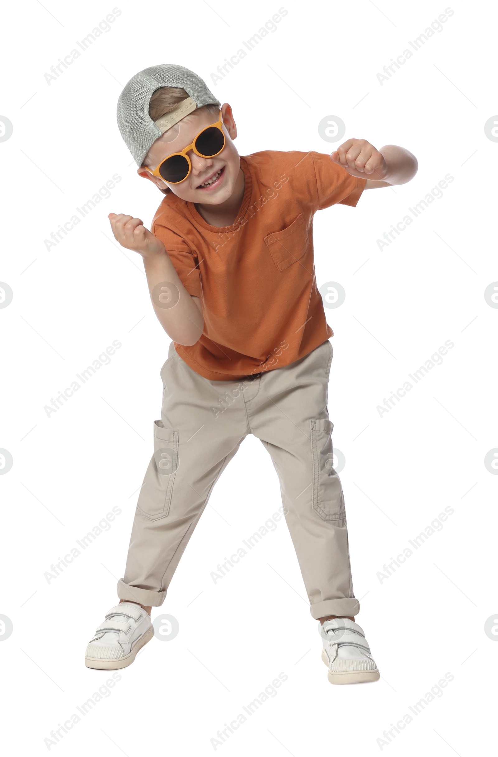 Happy little boy with sunglasses dancing on white background Photo of Happy little boy with sunglasses dancing on white background
