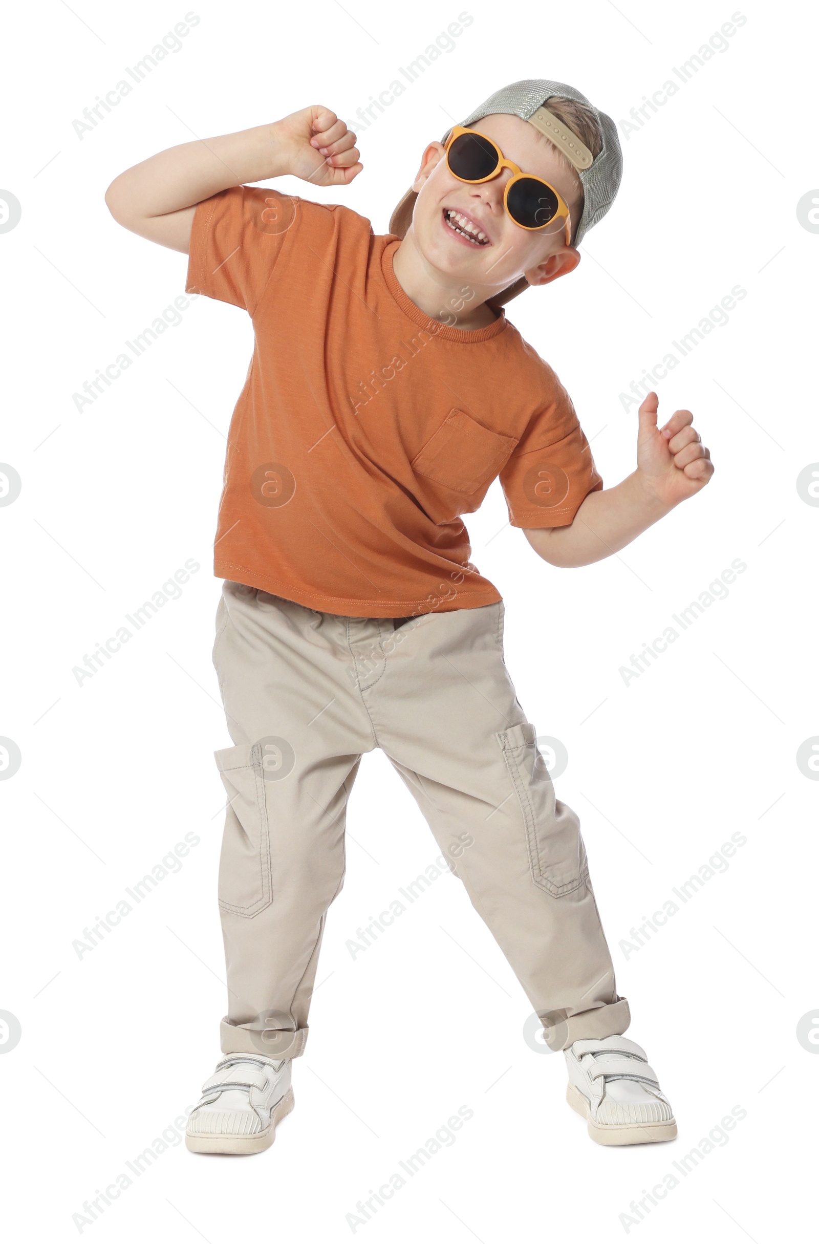 Happy little boy with sunglasses dancing on white background Photo of Happy little boy with sunglasses dancing on white background