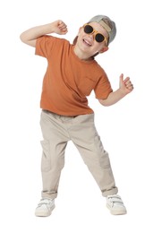 Photo of Happy little boy with sunglasses dancing on white background