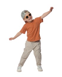 Photo of Happy little boy with sunglasses dancing on white background