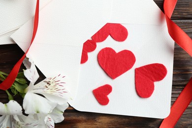 Photo of Many love letters, red hearts, ribbon and beautiful lilies on wooden table, above view