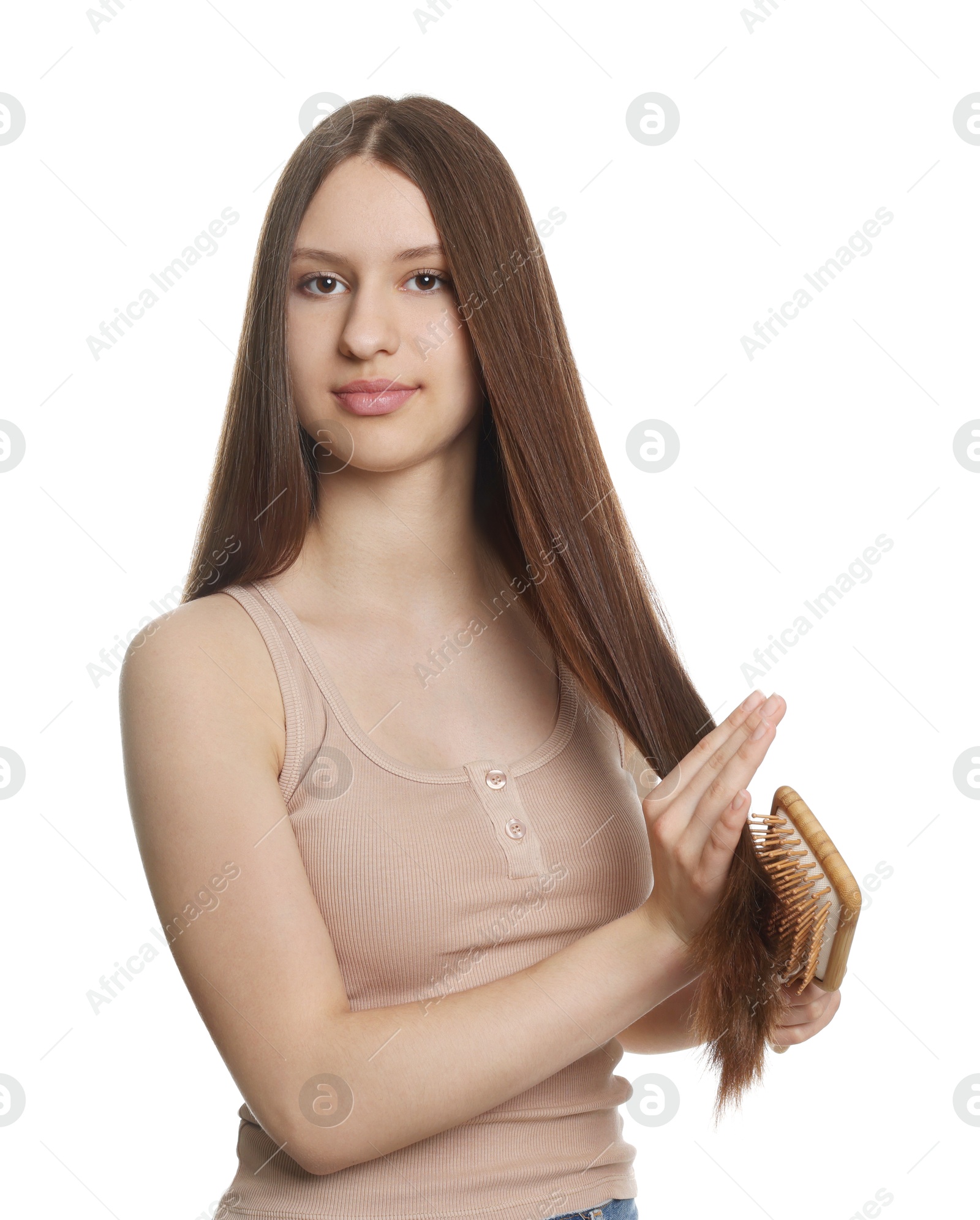 Beautiful teenage girl brushing her shiny hair on white background Photo of Beautiful teenage girl brushing her shiny hair on white background