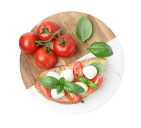 Photo of Tasty sandwich with mozzarella cheese, tomatoes and basil isolated on white, top view