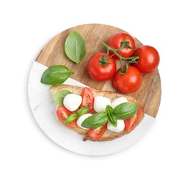 Photo of Tasty sandwich with mozzarella cheese, tomatoes and basil isolated on white, top view