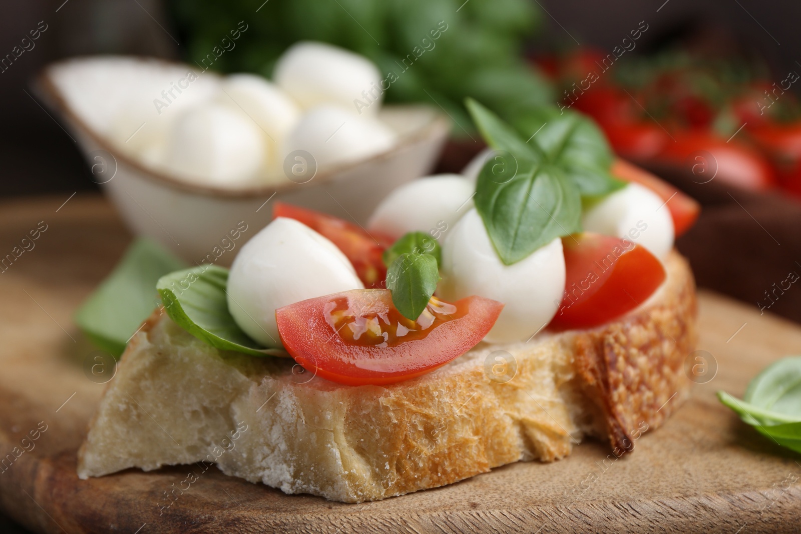Tasty sandwich with mozzarella cheese, tomatoes and basil on table, closeup Photo of Tasty sandwich with mozzarella cheese, tomatoes and basil on table, closeup