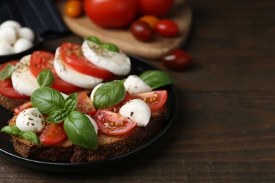 Photo of Tasty sandwiches with mozzarella cheese, tomatoes, basil and spices on wooden table, closeup. Space for text