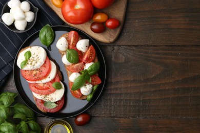 Photo of Tasty sandwiches with mozzarella cheese, tomatoes, basil and spices on wooden table, flat lay. Space for text