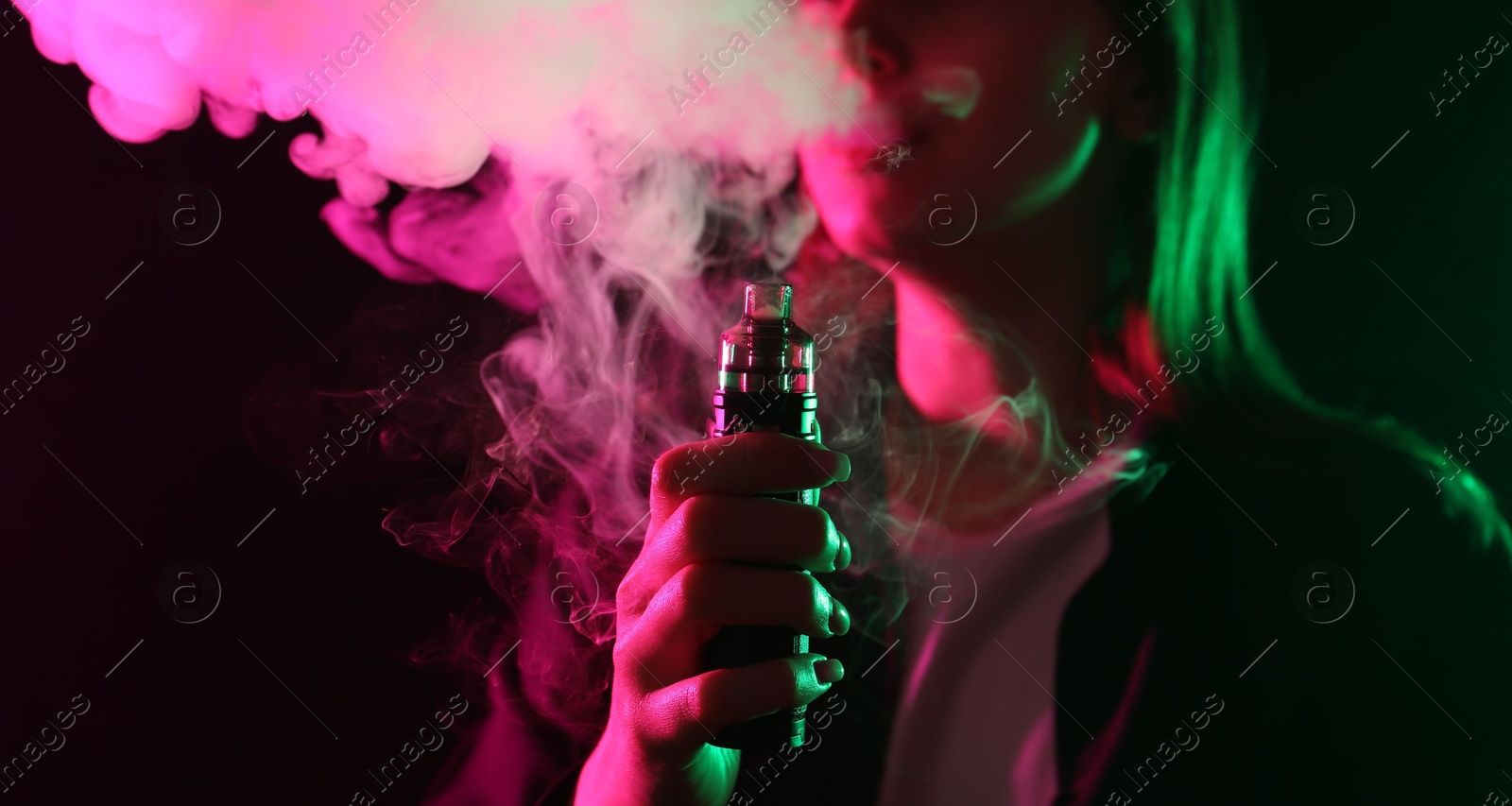 Woman using electronic smoking device in neon lights on black background, closeup. Space for text Photo of Woman using electronic smoking device in neon lights on black background, closeup. Space for text