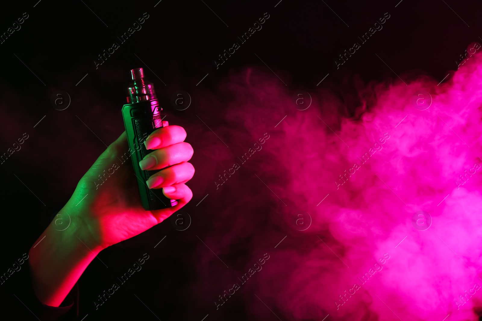 Woman using electronic smoking device in neon lights on black background, closeup. Space for text Photo of Woman using electronic smoking device in neon lights on black background, closeup. Space for text
