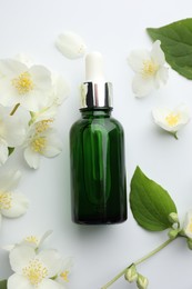 Photo of Essential oil, jasmine flowers and green leaves on white background, flat lay