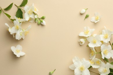 Photo of Beautiful jasmine flowers on beige background, flat lay. Space for text