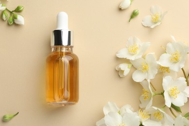 Photo of Essential oil and beautiful jasmine flowers on beige background, flat lay