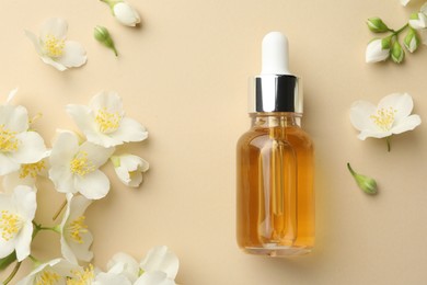 Photo of Essential oil and beautiful jasmine flowers on beige background, flat lay