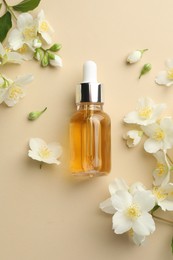 Photo of Essential oil and beautiful jasmine flowers on beige background, flat lay