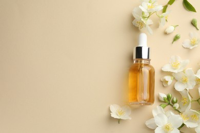 Photo of Essential oil and beautiful jasmine flowers on beige background, flat lay. Space for text