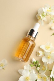 Photo of Essential oil and beautiful jasmine flowers on beige background, flat lay