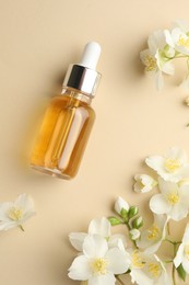 Photo of Essential oil and beautiful jasmine flowers on beige background, flat lay