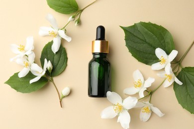 Photo of Essential oil, beautiful jasmine flowers and green leaves on beige background, flat lay
