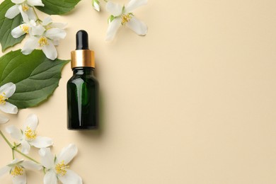 Photo of Essential oil, beautiful jasmine flowers and green leaves on beige background, flat lay. Space for text