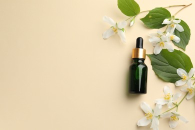 Photo of Essential oil, beautiful jasmine flowers and green leaves on beige background, flat lay. Space for text