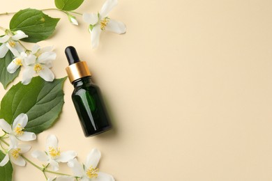 Photo of Essential oil, beautiful jasmine flowers and green leaves on beige background, flat lay. Space for text